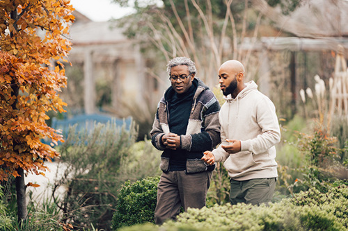 Two men walking in the hospice gardens