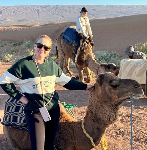 Amy with a camel in the desert
