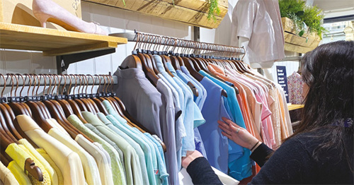 Customer browsing clothes rails